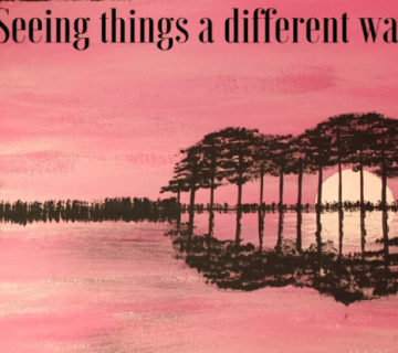 A pink sunset over calm water, with trees and their reflection forming the shape of an eye  Text at the top reads, "Seeing things a different way 